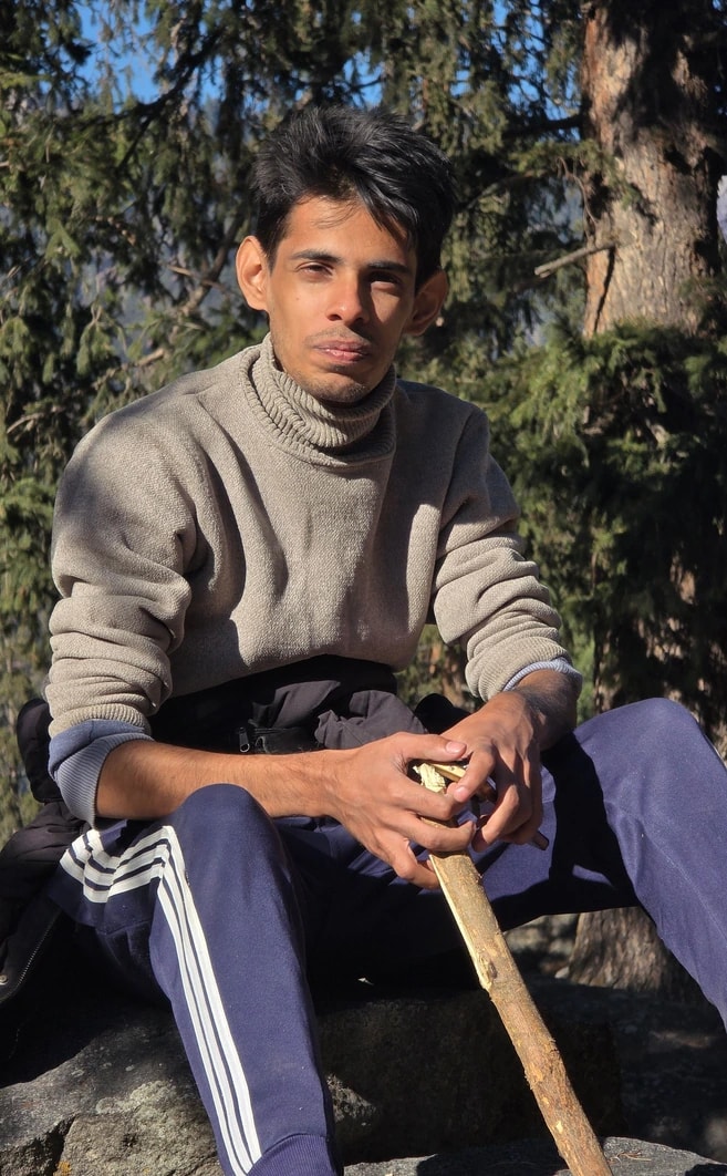 Abdullah outdoors, seated